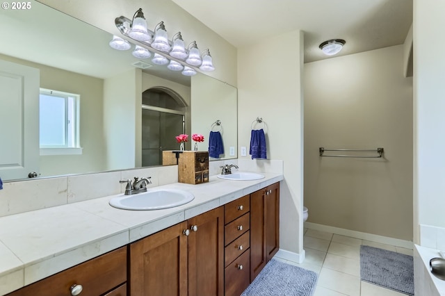 9288 SW Diamond View Way, Beaverton, OR 97007 - bathroom with double vanity, tile patterned flooring, toilet, a shower with shower door, and baseboards
