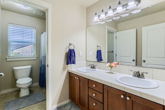 9288 SW Diamond View Way, Beaverton, OR 97007 - bathroom with toilet, double vanity, baseboards, and tile patterned floors
