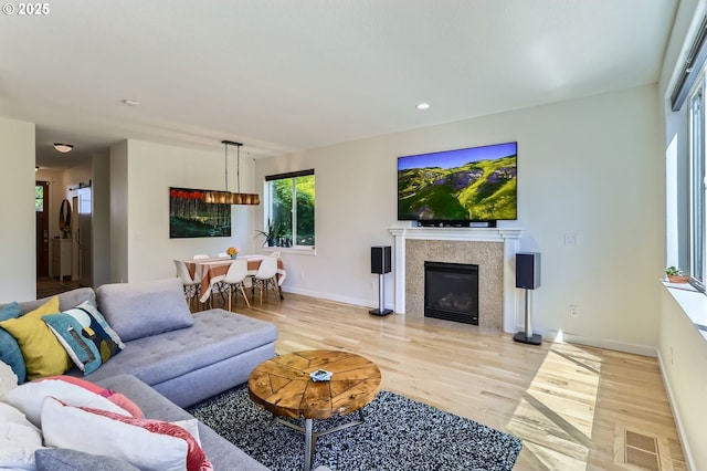 9288 SW Diamond View Way, Beaverton, OR 97007 - living area featuring wood finished floors, baseboards, a glass covered fireplace, and recessed lighting