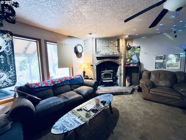 818 NW 359th St, La Center, WA 98629 - carpeted living room featuring a wood stove, ceiling fan, and a textured ceiling