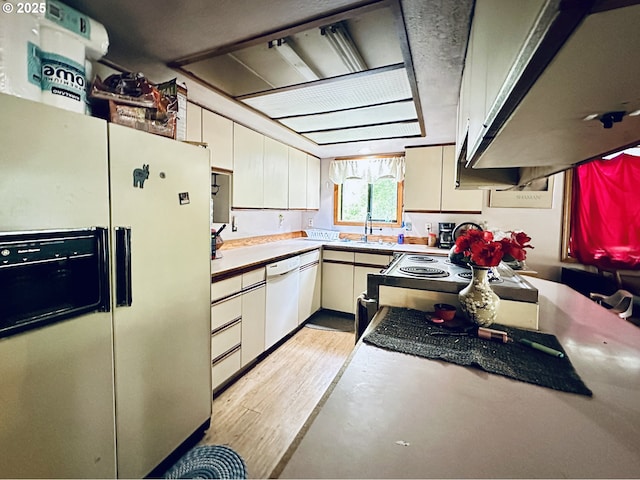 818 NW 359th St, La Center, WA 98629 - kitchen with white appliances, extractor fan, white cabinetry, light countertops, and light wood finished floors