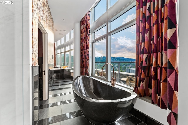 3601 S River Pkwy Unit 3101, Portland, OR 97239 - bathroom with a freestanding tub, vanity, a mountain view, and recessed lighting