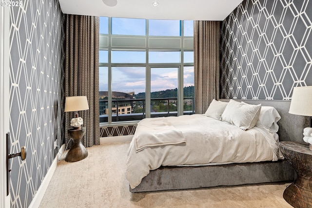 3601 S River Pkwy Unit 3101, Portland, OR 97239 - carpeted bedroom featuring wallpapered walls and a wall of windows