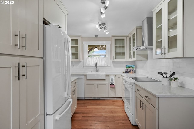 2110 NW Kings Blvd, Corvallis, OR 97330 - kitchen featuring white appliances, a sink, wall chimney range hood, backsplash, and decorative light fixtures