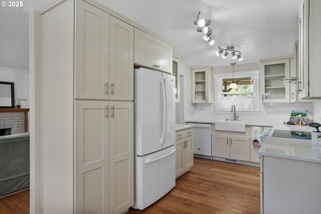 2110 NW Kings Blvd, Corvallis, OR 97330 - kitchen with white appliances, a sink, backsplash, wood finished floors, and glass insert cabinets