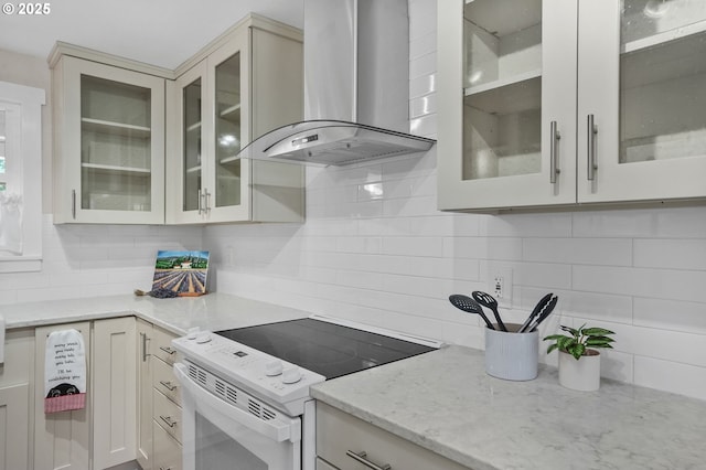2110 NW Kings Blvd, Corvallis, OR 97330 - kitchen featuring electric range, wall chimney range hood, decorative backsplash, light stone countertops, and glass insert cabinets