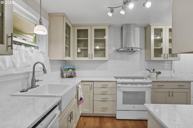 2110 NW Kings Blvd, Corvallis, OR 97330 - kitchen with wall chimney range hood, white range with electric stovetop, cream cabinets, and tasteful backsplash