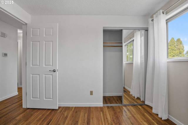 2110 NW Kings Blvd, Corvallis, OR 97330 - unfurnished bedroom featuring a closet, wood finished floors, baseboards, and a textured ceiling