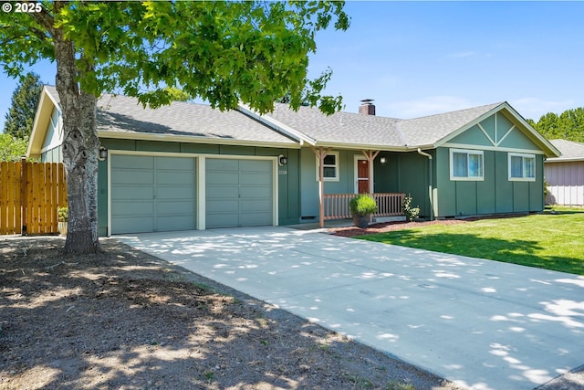 2110 NW Kings Blvd, Corvallis, OR 97330 - single story home with an attached garage, a porch, a chimney, board and batten siding, and driveway