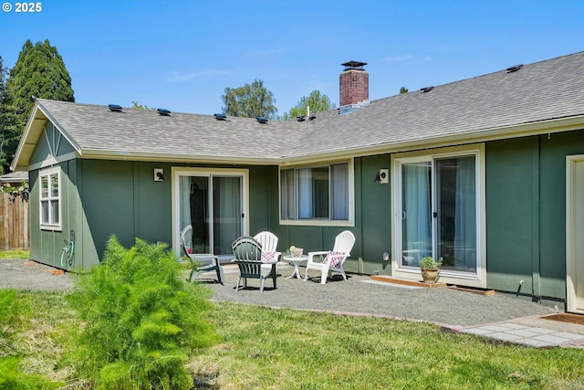 2110 NW Kings Blvd, Corvallis, OR 97330 - rear view of property with a chimney, roof with shingles, a patio, and a yard