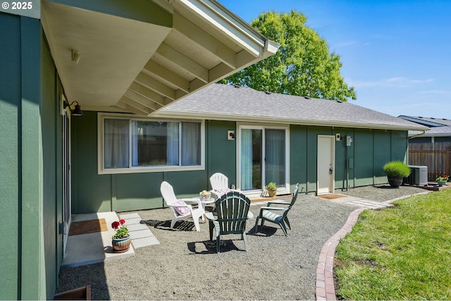 2110 NW Kings Blvd, Corvallis, OR 97330 - back of house featuring a patio area, fence, roof with shingles, and cooling unit