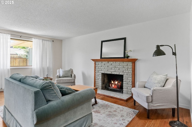 2110 NW Kings Blvd, Corvallis, OR 97330 - living room with a brick fireplace, a textured ceiling, and wood finished floors