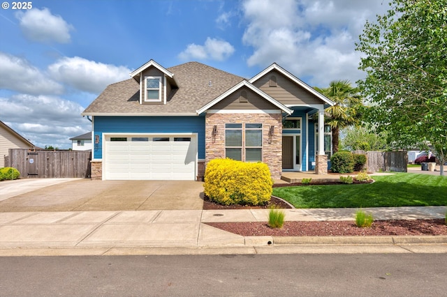 craftsman-style home featuring an attached garage, stone siding, concrete driveway, and a shingled roof