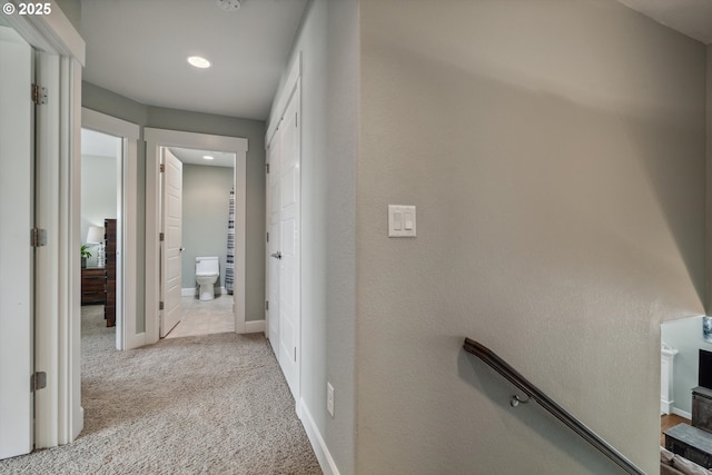 corridor featuring carpet flooring, recessed lighting, and baseboards