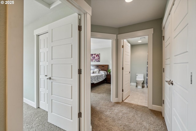 corridor with light carpet, baseboards, and recessed lighting