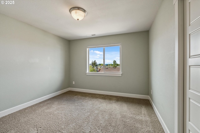 unfurnished room with carpet flooring and baseboards