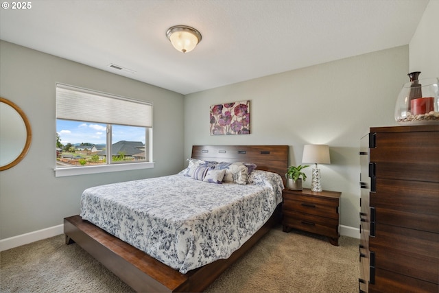 bedroom with carpet flooring and baseboards