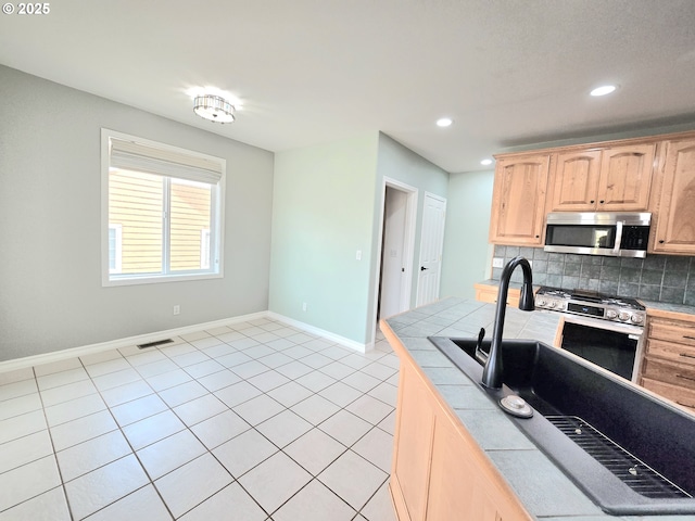 292 Jamie Loop, Roseburg, OR 97471 - kitchen featuring appliances with stainless steel finishes, tile countertops, light brown cabinetry, decorative backsplash, and recessed lighting