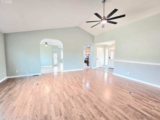 292 Jamie Loop, Roseburg, OR 97471 - unfurnished living room with ceiling fan, arched walkways, wood finished floors, and high vaulted ceiling