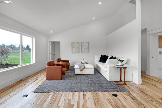 living area with baseboards, vaulted ceiling, recessed lighting, and wood finished floors