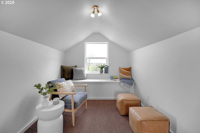 living area featuring carpet floors and vaulted ceiling