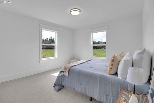 bedroom featuring baseboards and carpet