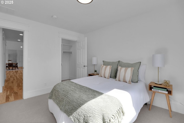 bedroom with baseboards and carpet