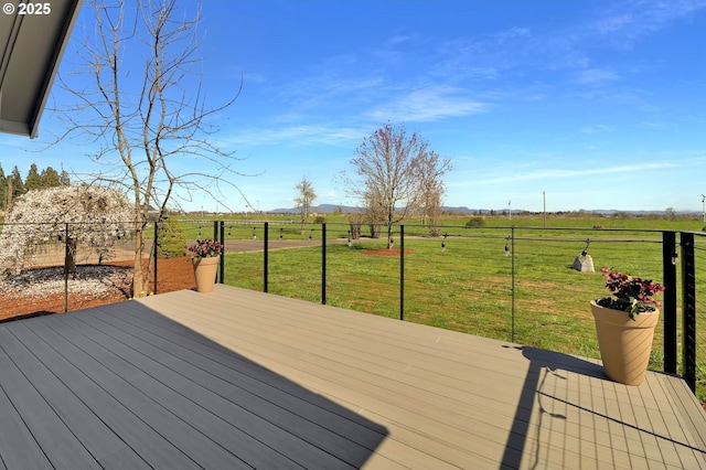wooden deck featuring a mountain view, a yard, and a rural view