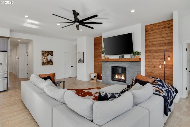 1654 NE Joy Ln, Estacada, OR 97023 - living area with ceiling fan, recessed lighting, a fireplace, light wood finished floors, and wooden walls