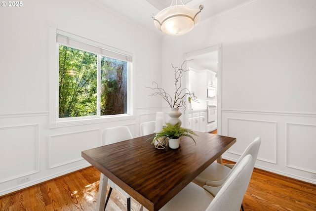 2360 Michael, West Linn, OR 97068 - dining space featuring a decorative wall, crown molding, light wood-type flooring, and wainscoting