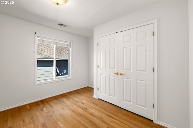 2360 Michael, West Linn, OR 97068 - unfurnished bedroom featuring baseboards, light wood-style floors, and a closet