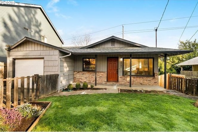 view of front of property featuring a porch, an attached garage, brick siding, fence, and a front yard