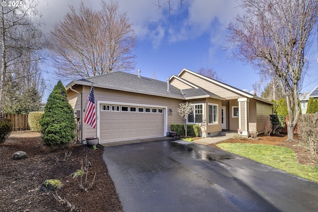 ranch-style home with aphalt driveway, an attached garage, fence, and a shingled roof