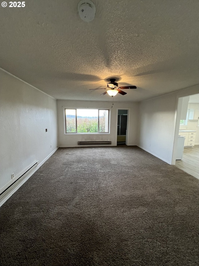 carpeted spare room with a baseboard radiator, ceiling fan, and a textured ceiling