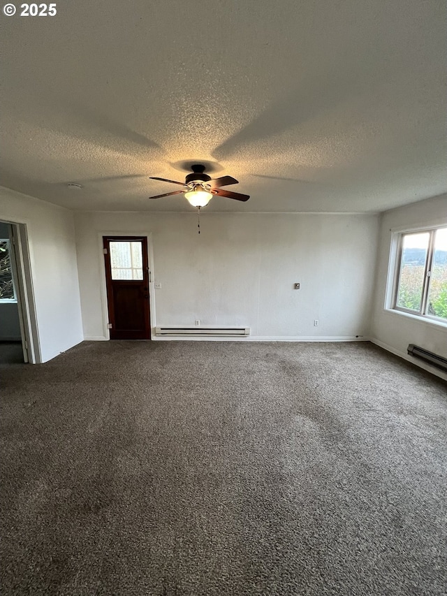 interior space with ceiling fan, a textured ceiling, and baseboard heating