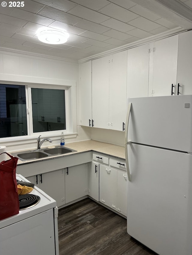 kitchen with dark hardwood / wood-style floors, sink, white cabinets, crown molding, and white appliances