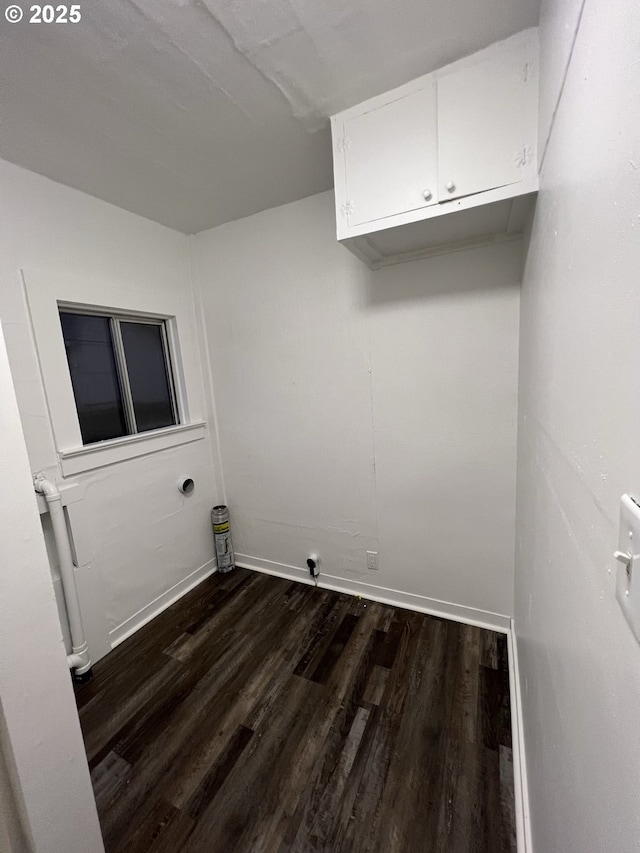 clothes washing area with dark hardwood / wood-style flooring