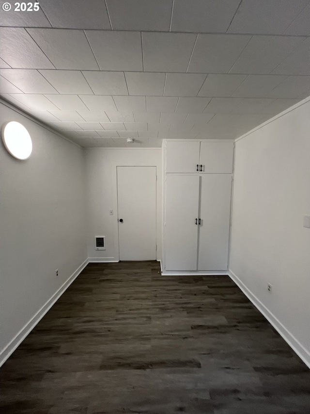 basement with dark hardwood / wood-style flooring