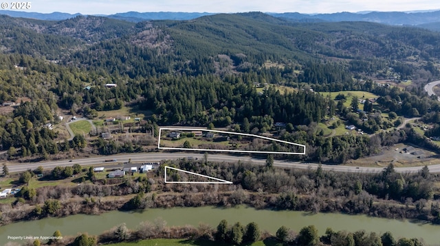 birds eye view of property featuring a water and mountain view