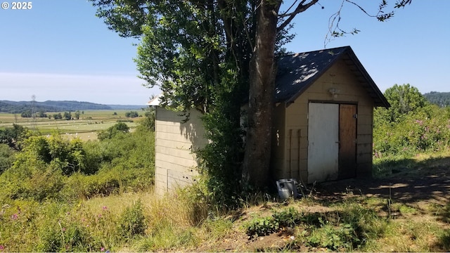 view of outbuilding with a rural view