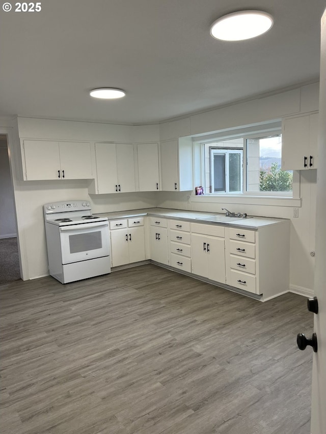 kitchen with sink, white electric range, white cabinets, and light hardwood / wood-style floors