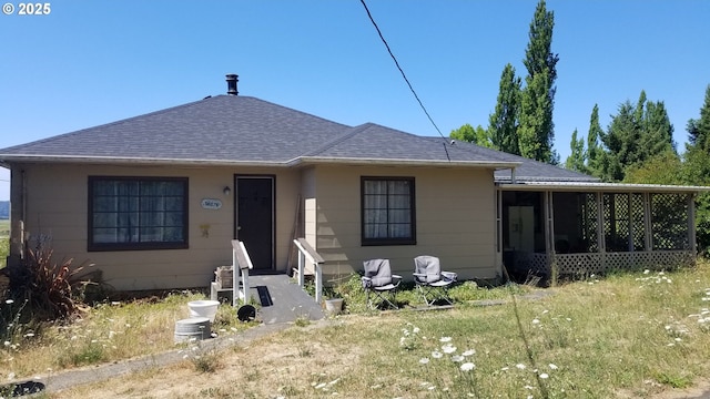 view of front of home with a sunroom