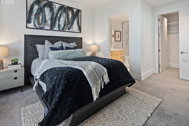 550 SW 10th Ave Unit 2306, Portland, OR 97205 - carpeted bedroom featuring baseboards, connected bathroom, and a spacious closet