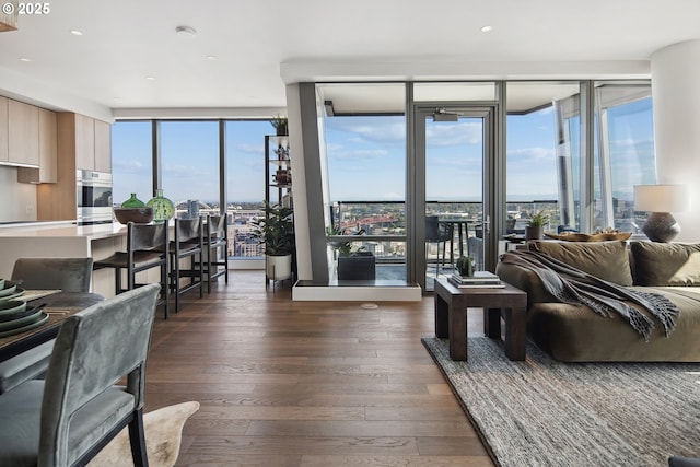 550 SW 10th Ave Unit 2306, Portland, OR 97205 - living room featuring dark wood-style flooring, recessed lighting, and expansive windows