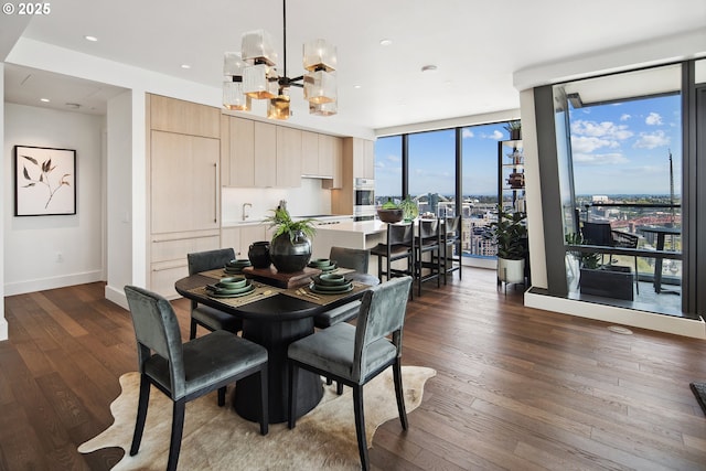 550 SW 10th Ave Unit 2306, Portland, OR 97205 - dining area featuring an inviting chandelier, a wall of windows, dark wood finished floors, recessed lighting, and baseboards