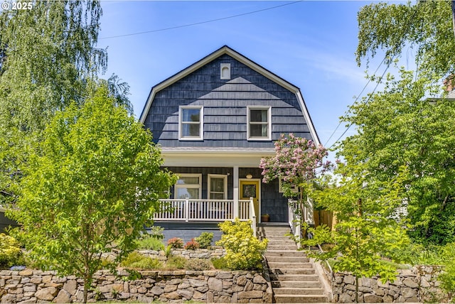 2229 NE 8th Ave, Portland, OR 97212 - colonial inspired home featuring a gambrel roof, covered porch, and stairway