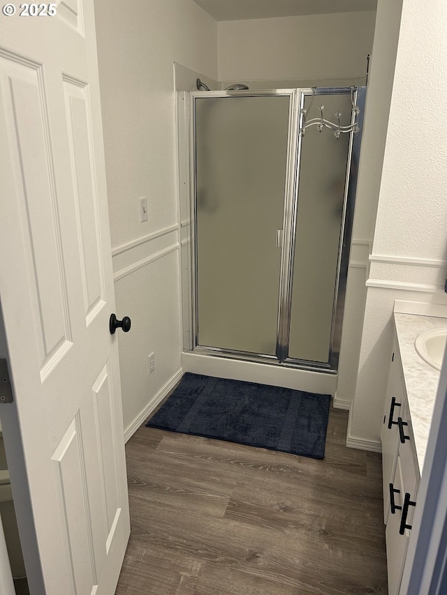 715 N 16th St, Cottage Grove, OR 97424 - bathroom with vanity, a stall shower, wood finished floors, and baseboards