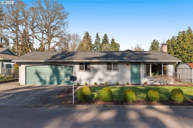 ranch-style home with fence, driveway, an attached garage, a chimney, and a front lawn