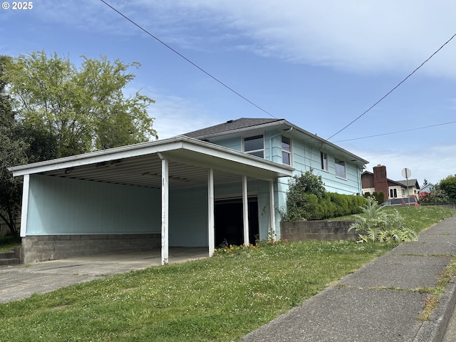 607 Commercial St, North Bend, OR 97459 - view of side of property with driveway, a yard, and an attached carport