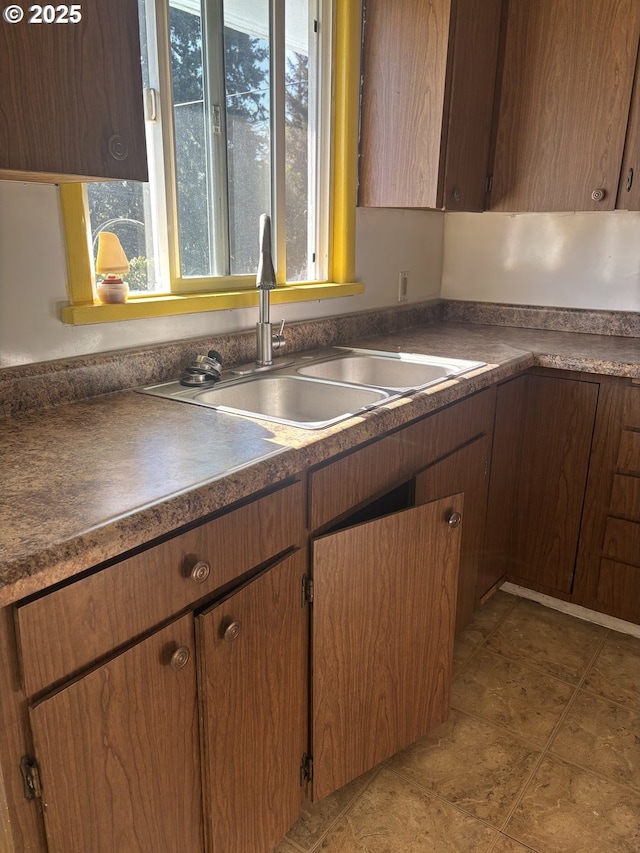 607 Commercial St, North Bend, OR 97459 - kitchen featuring a sink, dark countertops, and light tile patterned floors